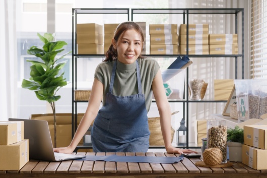 Go green vendor use eco packaging parcel carton box in net zero waste store asian seller retail home office shop. Small SME owner young adult woman asia Gen Z people happy smile pride look at camera.