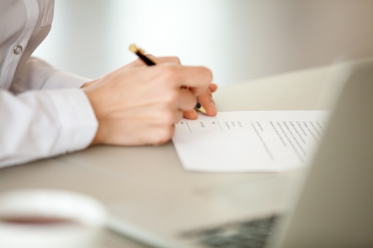 Businesswoman signing paper, female hand puts signature on business document making employment contract agreement, taking bank loan insurance concept, patent certificate registration, close up view