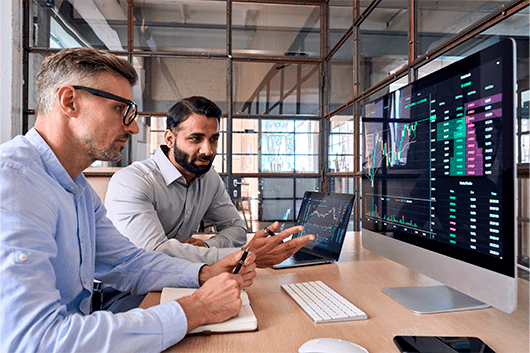 business people discussing in front of a computer